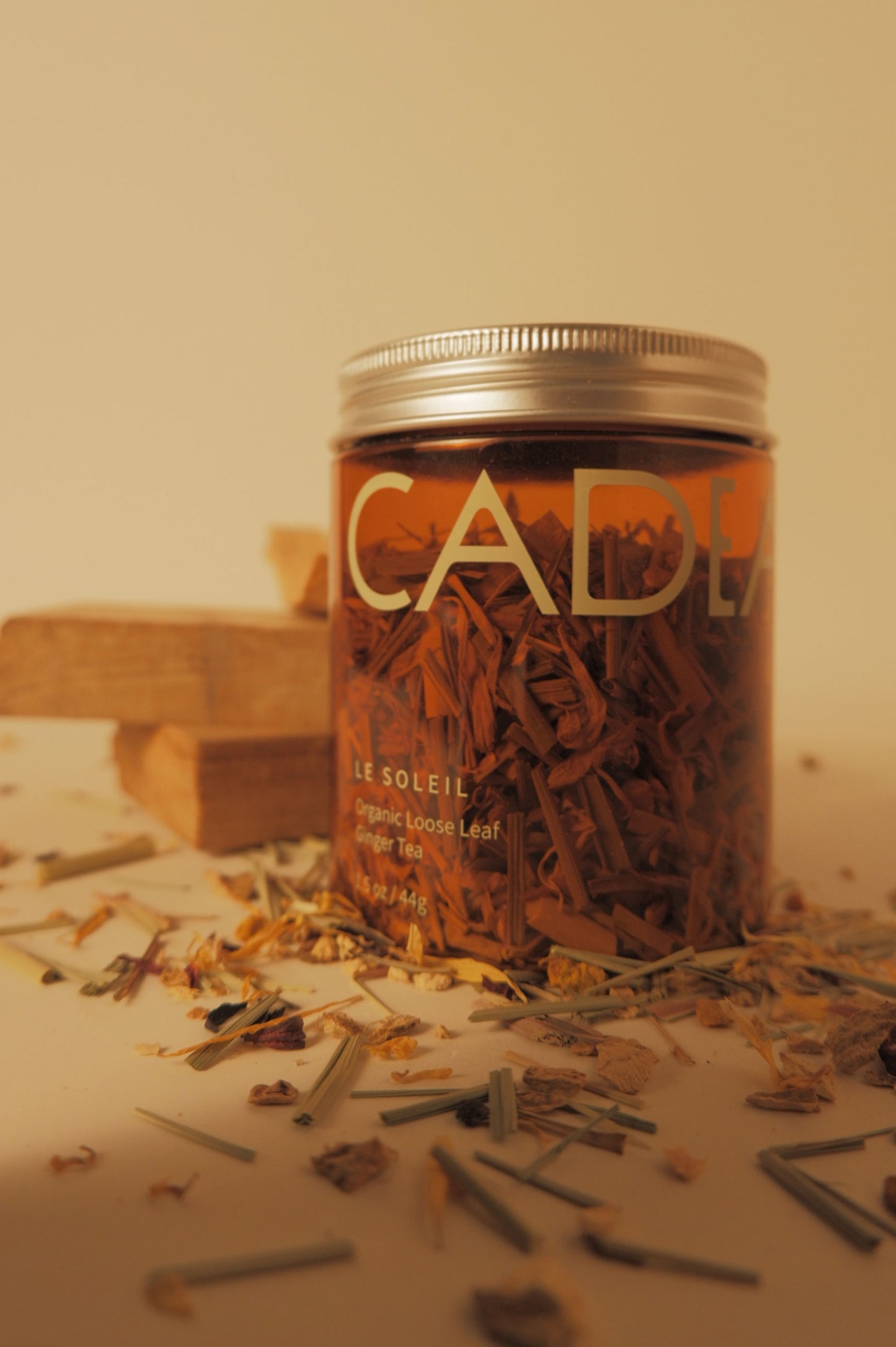 Moody tea jar with tea sprinkled in front 