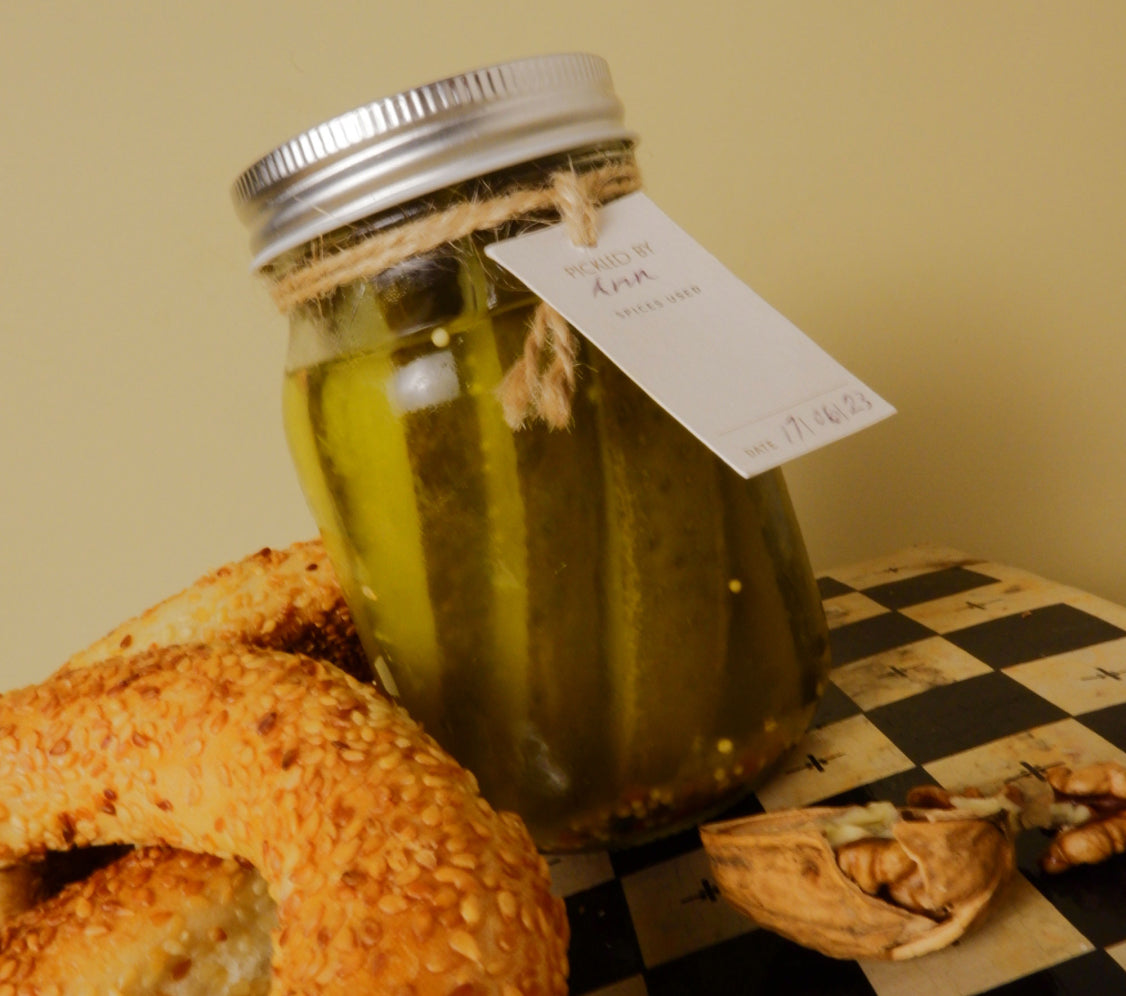 Pickle jar surrounded by pretzels. Pickling gift kit hamper
