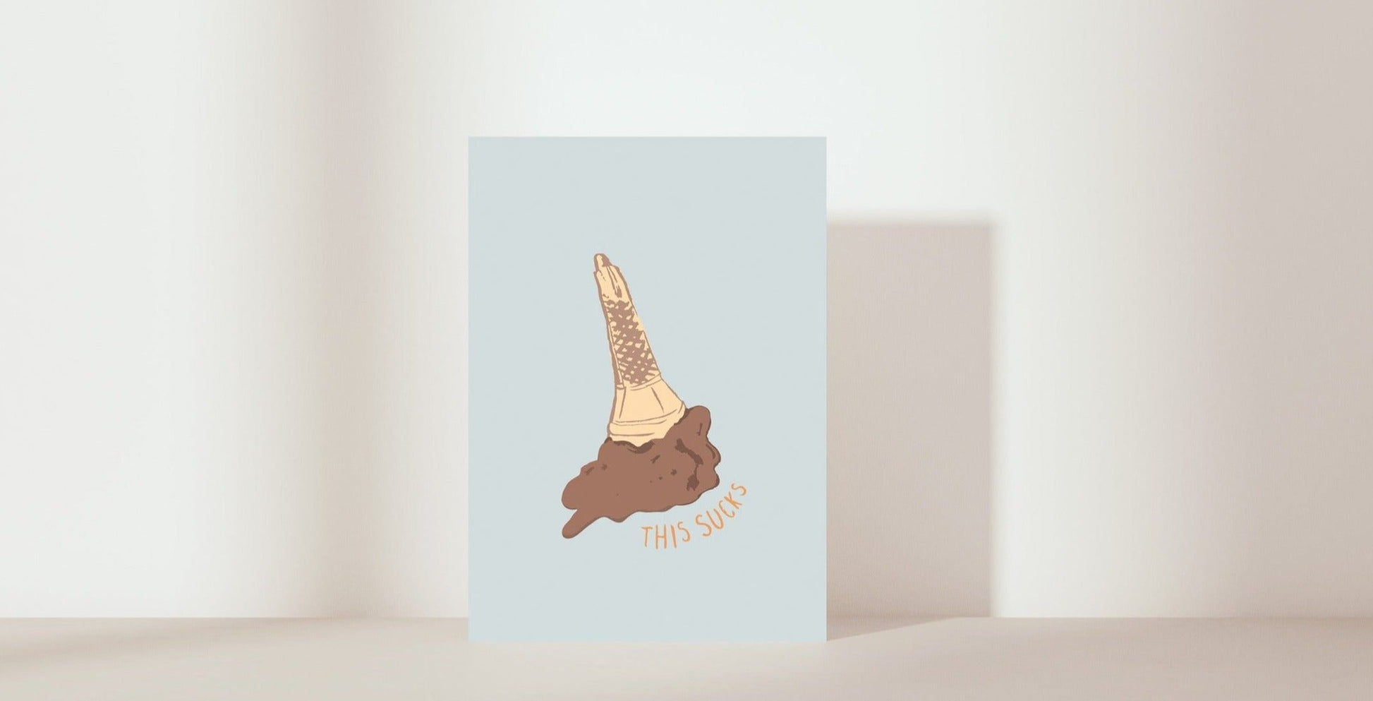 gift card illustration of upside down chocolate ice-cream in cone. Text = 'This sucks'. background colour = blue