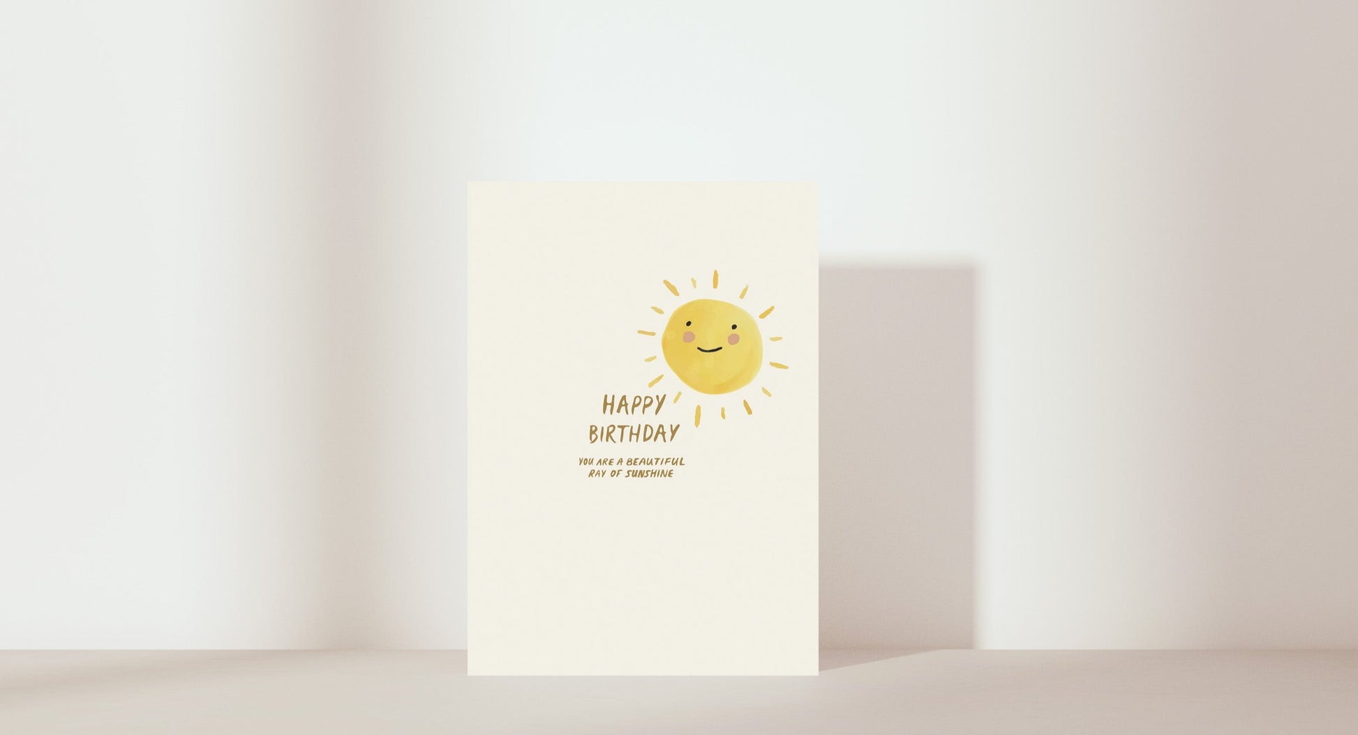 'Happy birthday. You are a beautiful ray of sunshine'. Image of sun smiling. Colour: yellow and neutral. 